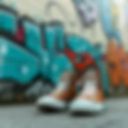 A stylish pair of brown Converse high tops against a graffiti wall