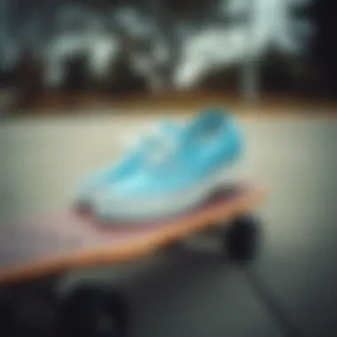 A pair of cool blue Vans placed on a skateboard deck