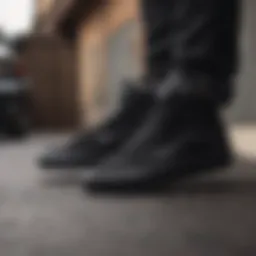 A stylish pair of black on black Vans displayed on a sleek surface