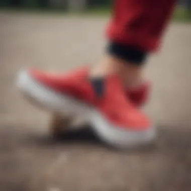 Red suede Vans slip-ons on a skateboard, emphasizing style and function