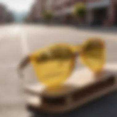 Stylish Yellow Lenses on Skateboard A close-up shot of a pair of stylish yellow-lensed sunglasses resting on a skateboard, showcasing their aesthetic appeal.