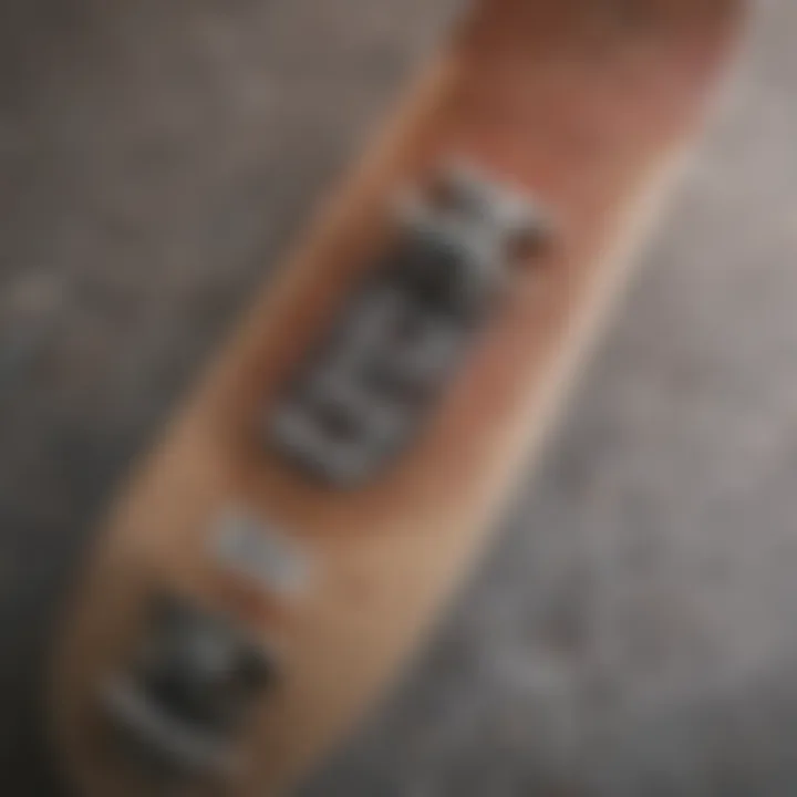 A close-up of skateboard deck with branded apparel displayed