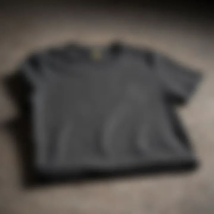 A stylish charcoal tee shirt displayed against a textured backdrop