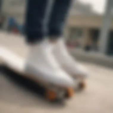 A close-up of white vans on a skateboard ramp showcasing the footwear in action.