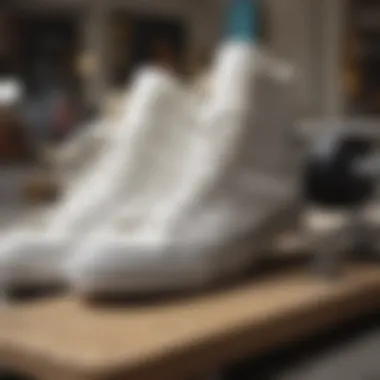 All-white Converse sneakers placed next to skateboard gear and accessories