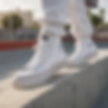 Close-up of all-white Converse sneakers highlighted in an urban skate park