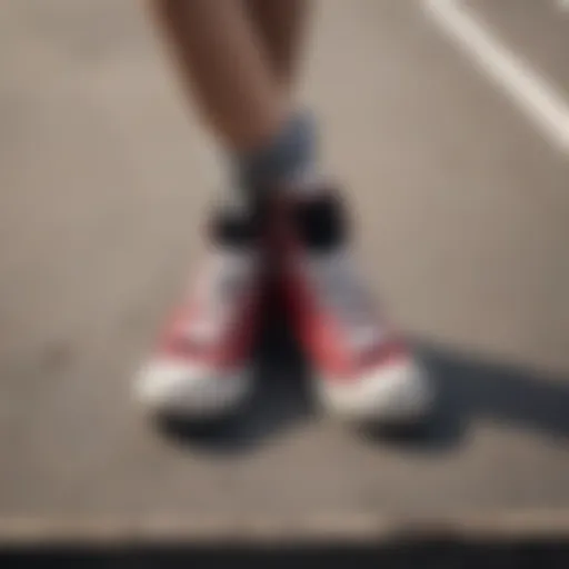 Artistic display of red and black Chuck Taylor sneakers on a skateboard