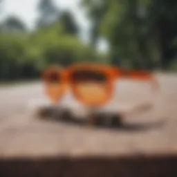 Vibrant orange Pit Viper sunglasses on a skateboard