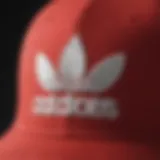 A close-up of the red and white Adidas hat showcasing its iconic logo and stitching details