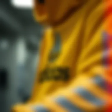 Close-up of the yellow Adidas hoodie highlighting its design features